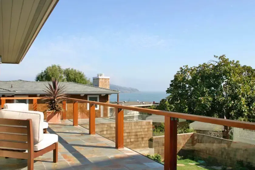 Deck with a railing and a view of the bay