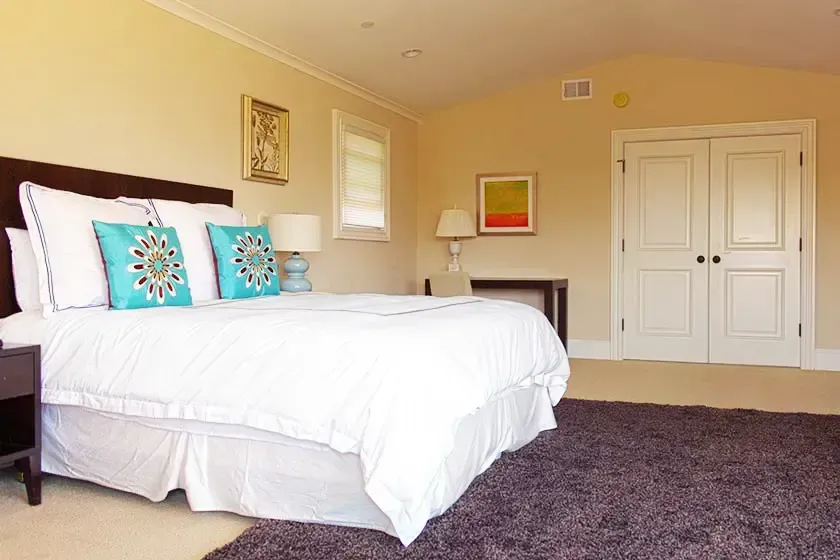 Private bedroom at Alta Mira with white bedding and natural light