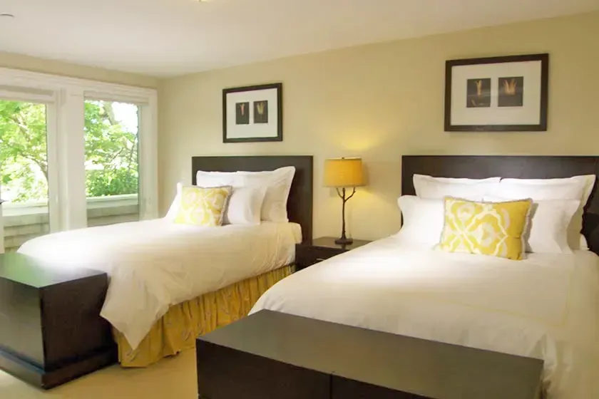 Shared bedroom with two beds and garden windows
