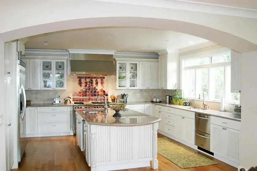 Bright kitchen with white cabinets and a center island