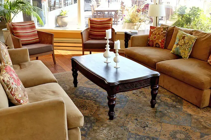 Lounge with sofas beneath tall bay windows