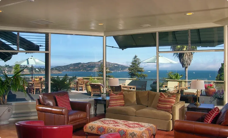 Sunroom lounge with windows looking out over the bay